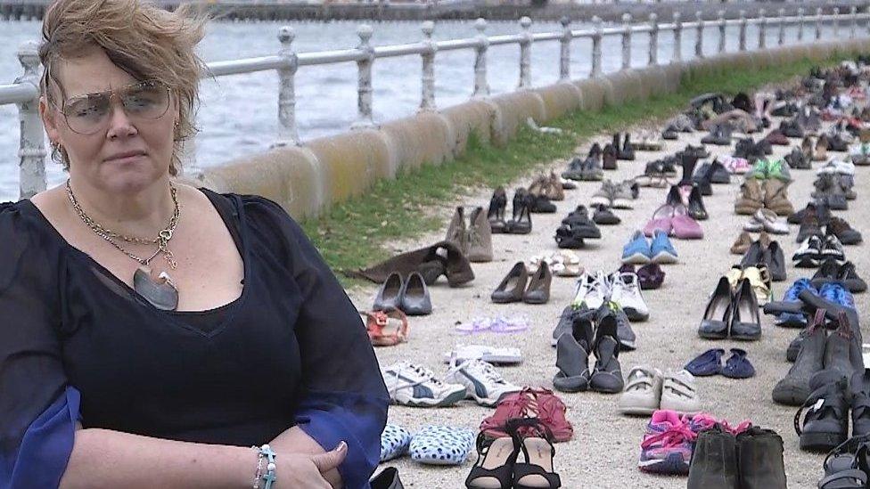 Fi Perez sitting in front of shoes