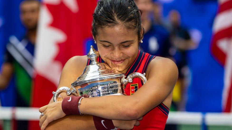 Smiling Emma Raducanu celebrates her victory in the final of the US Open