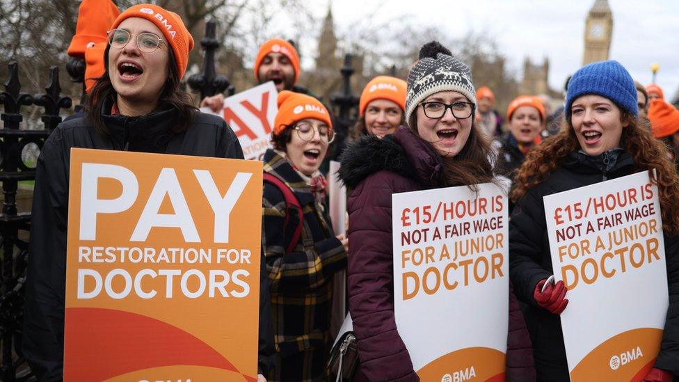 Staff holding placards outside St Thomas' Hospital in London