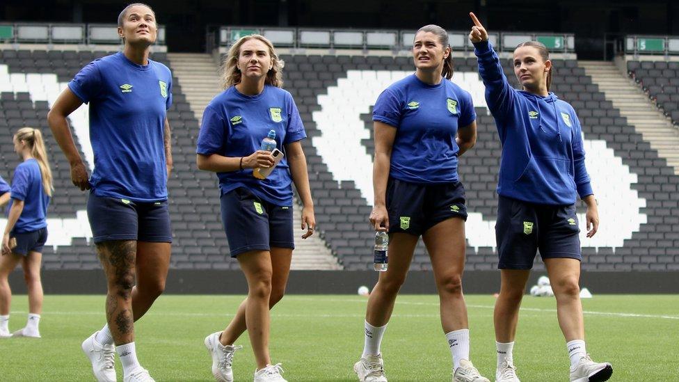 Natasha Thomas, Holly Turner, Maisie Barker and Maria Boswell in their warm up kit, on the stadium MK pitch before kick off.