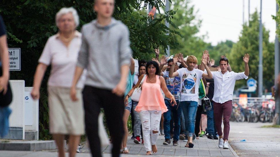 People walking away with their arms in the air