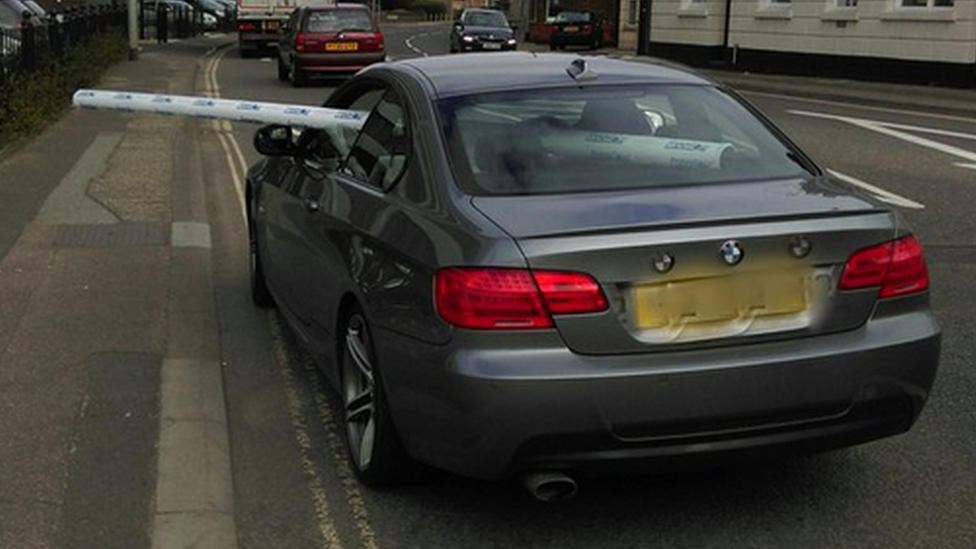 Car with guttering sticking out of window