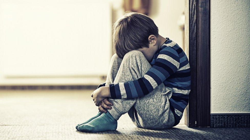 Boy sitting on floor