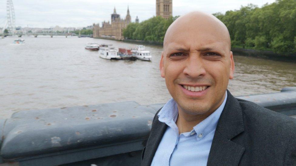 Samuel Williams standing on a bridge in front of the Houses of Parliament