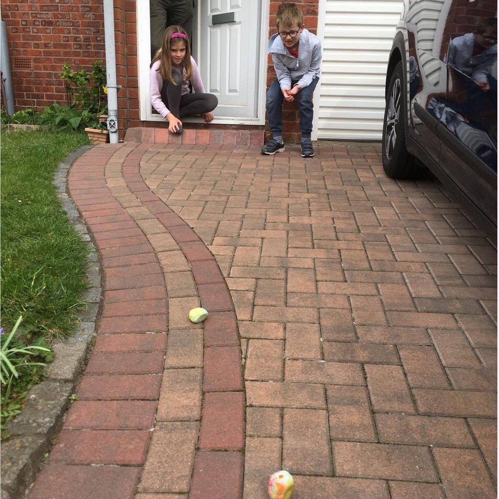 Naomi Leathes, 9, and Daniel Leathes, 7, rolling their eggs down the drive at their Edinburgh home on Easter Sunday