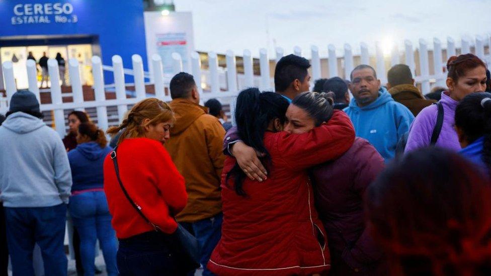 Relatives of inmates react outside the state prison