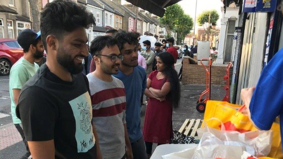 Greenwich university MBA students queue for food