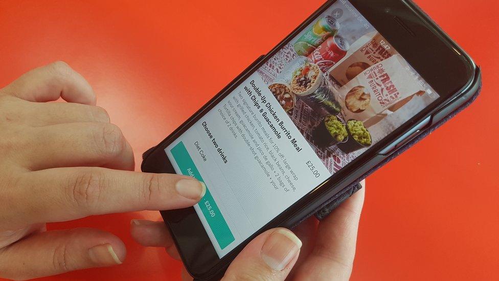 Hands shown using Deliveroo app