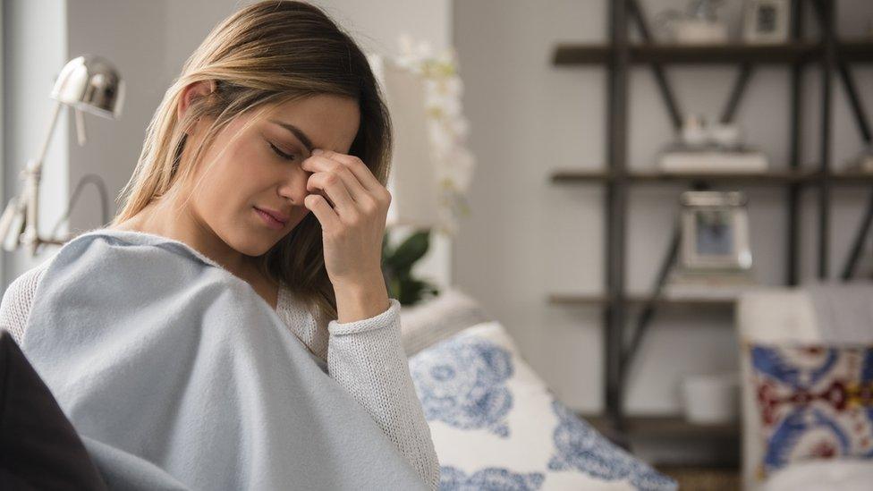 Tired woman holding head