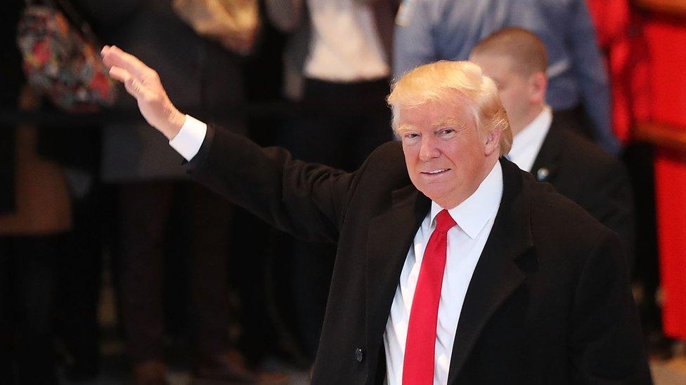 NOVEMBER 22: President-elect Donald Trump walks through the lobby of the New York Times following a meeting with editors at the paper