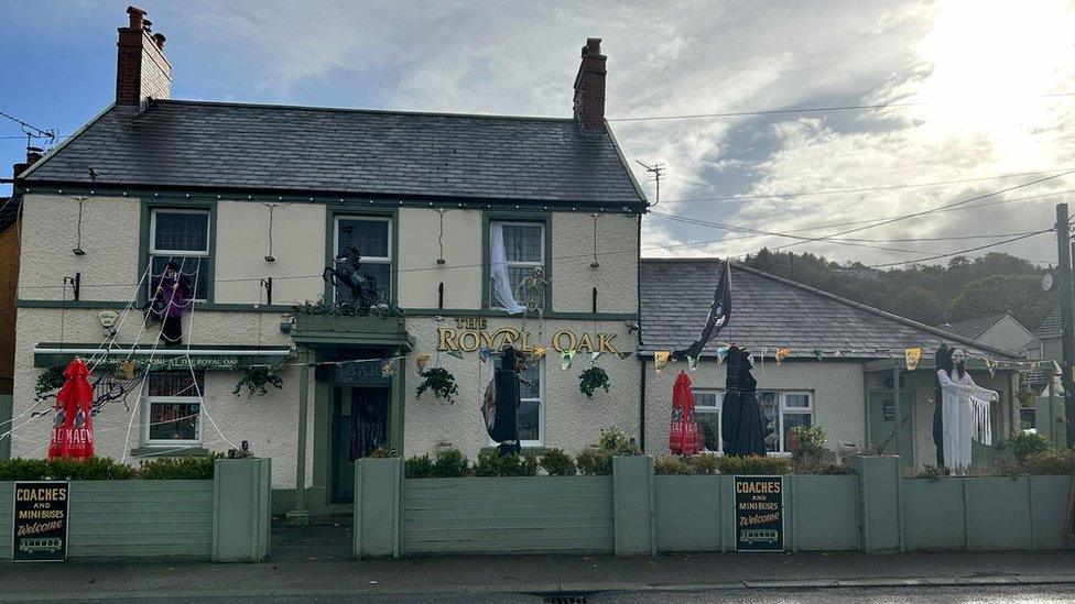 A still of The Royal Oak covered in Halloween decorations