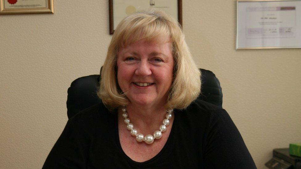 Susan Newbon sitting in her office