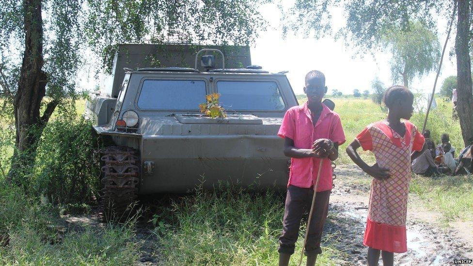 Children playing near an abandoned military vehicle