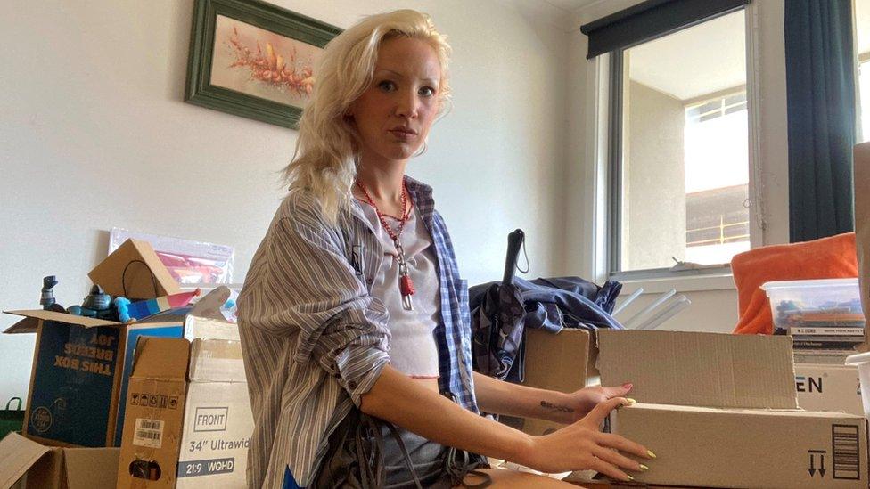 Hayley surrounded by boxes