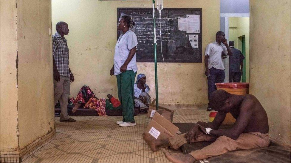 A protestor, right, injured during clashes receives treatment in a hospital in Ouagadougou, Burkina Faso, Thursday, Sept. 17, 2015