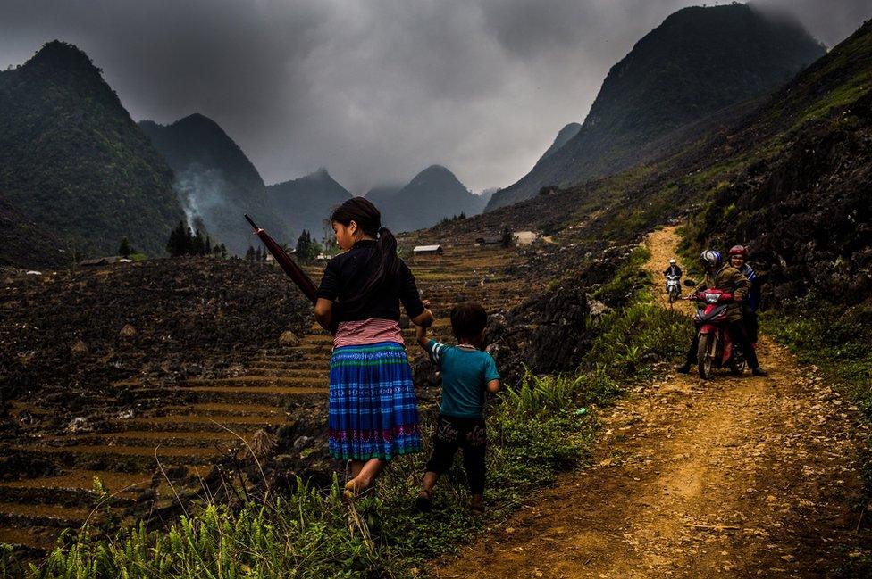 Children make their way through the landscape