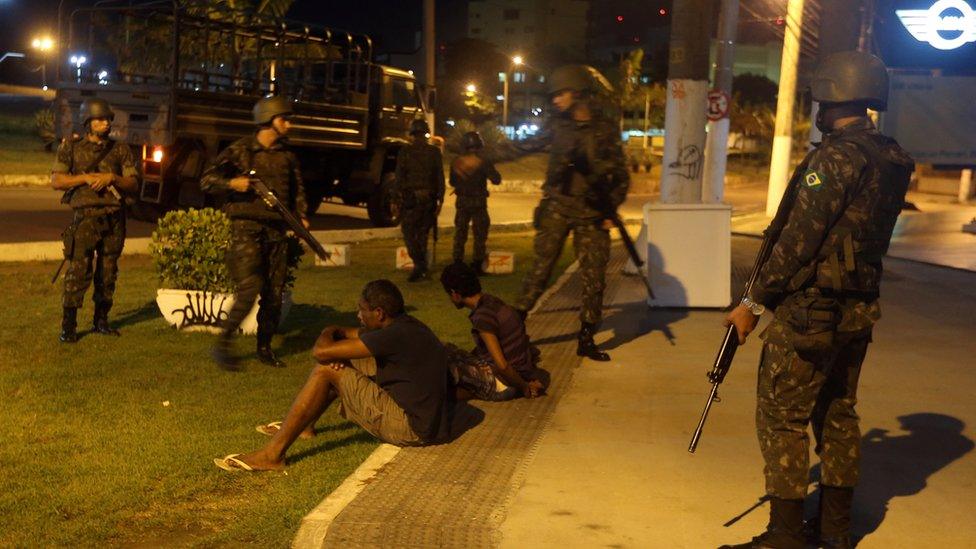 Soldiers detain two men suspected of stealing from stores in Vitoria, Espirito Santo, Brazil, 7 February 2017