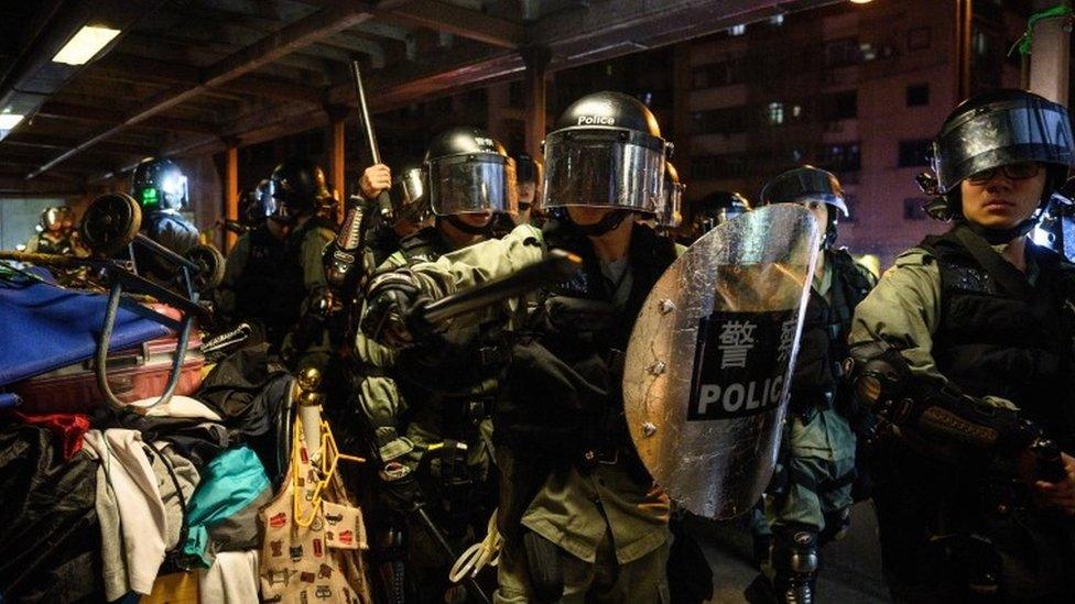 Police clear people from a bridge in the North Point area of Hong Kong on September 15, 2019