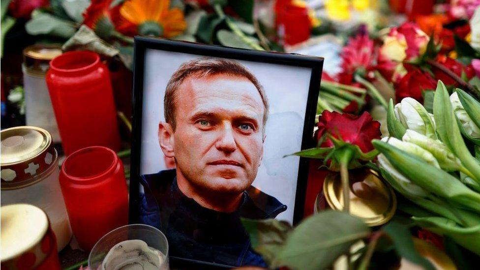 A picture of Alexi Navalny is surrounded by flowers