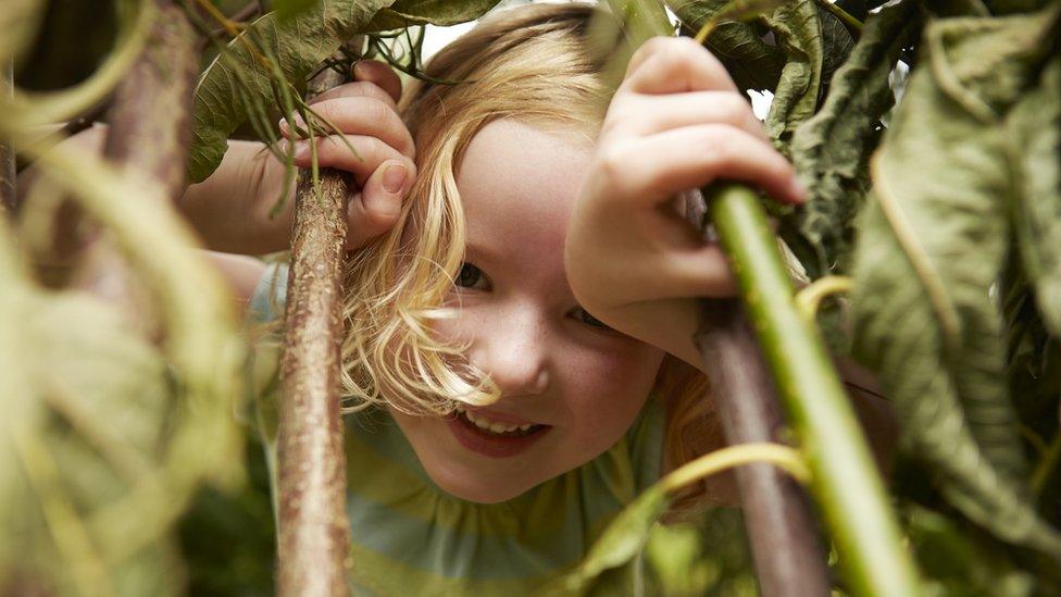 Girl in trees and bushes