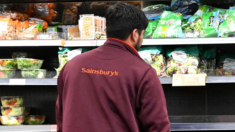 A worker in Sainsburys supermarket