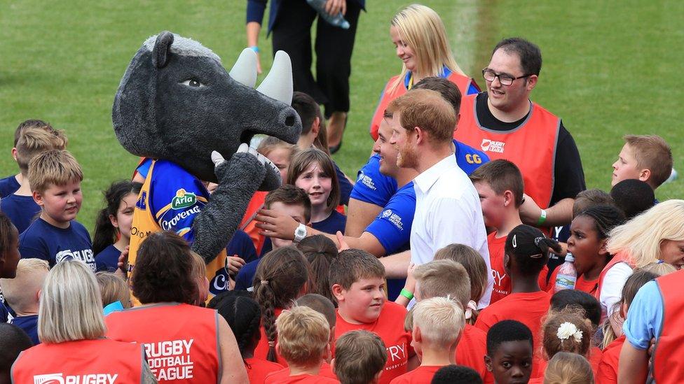 Prince Harry speaks to a mascot at Headingley Carnegie Stadium