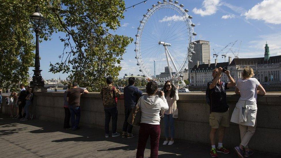 Tourists across the Thames from the London Eye