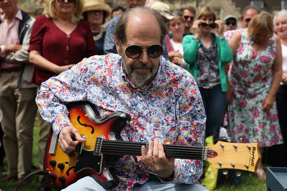 Musician Ray plays the guitar