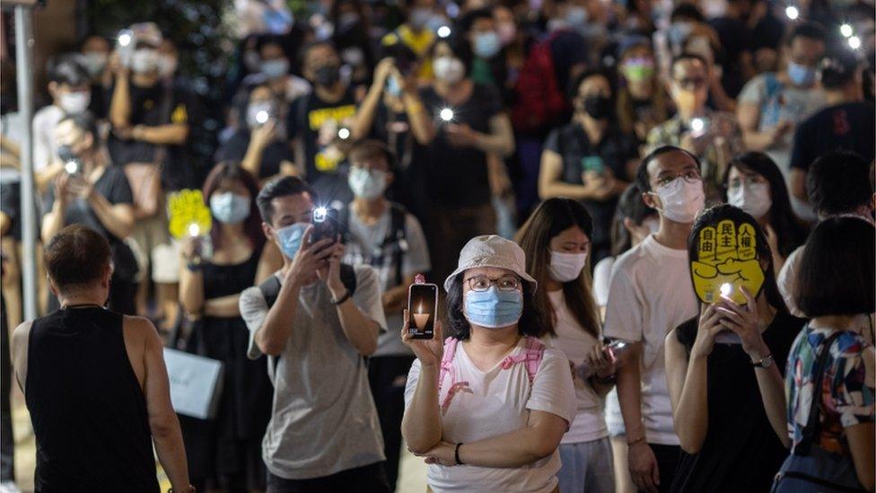 People hold their phone lights aloft to mark Tiananmen Square anniversary, June 2021