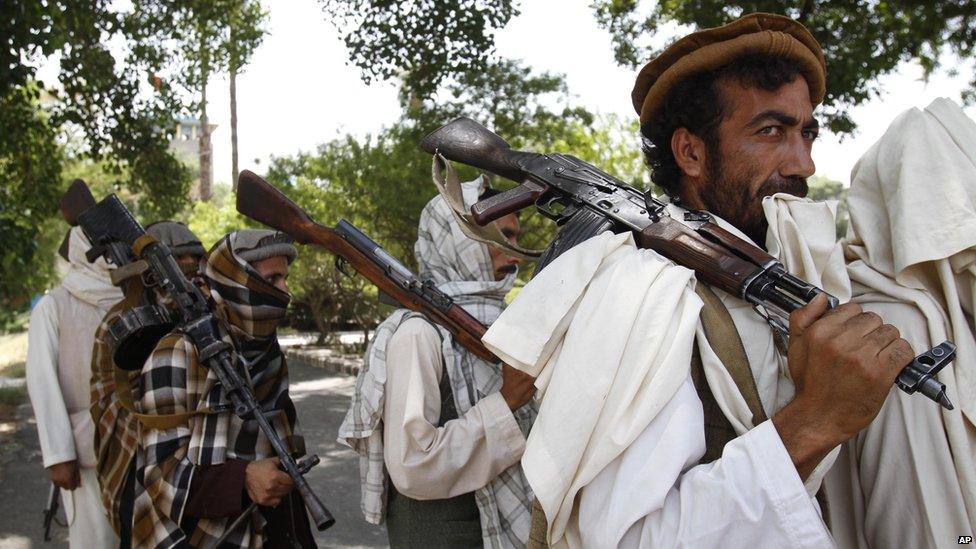 Taliban fighters hold their heavy and light weapons before surrendering them to Afghan authorities in Jalalabad, east of Kabul, Afghanistan