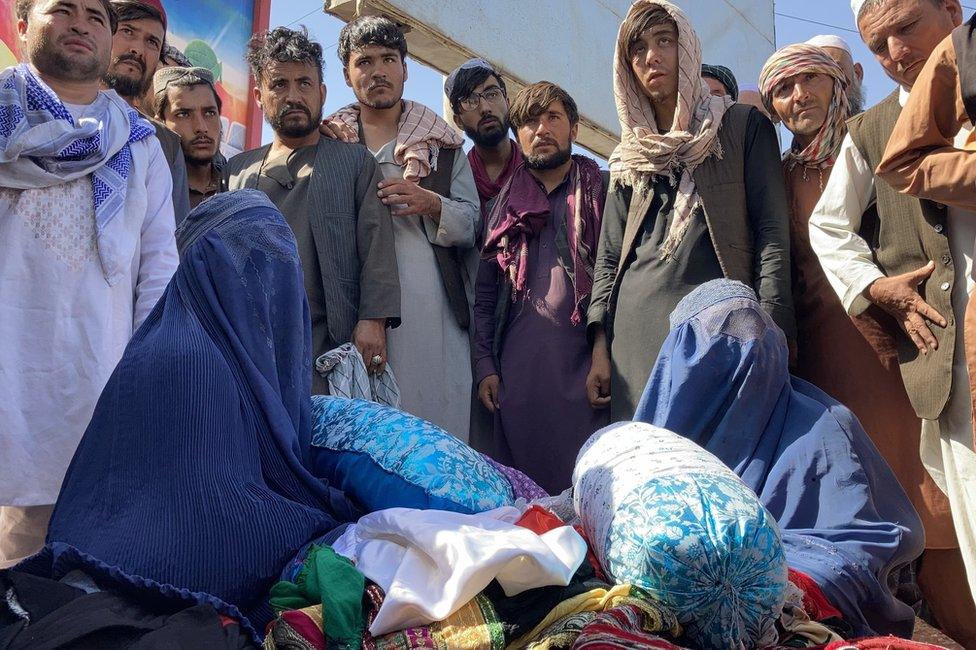 Shagufta at the market in Mazar-i-Sharif. "I am selling my children's finest clothes," she said.