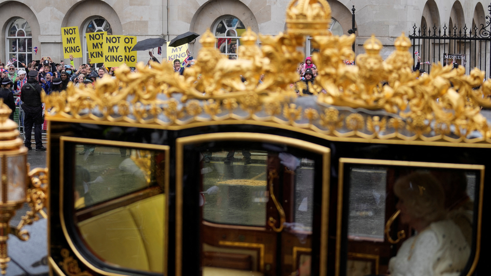 The King and Queen went past some of the protesters as they travelled in the Diamond Jubilee State Coach towards Westminster Abbey