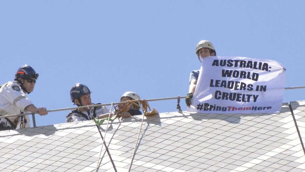 Police arrest activists on top of the Sydney Opera House sails