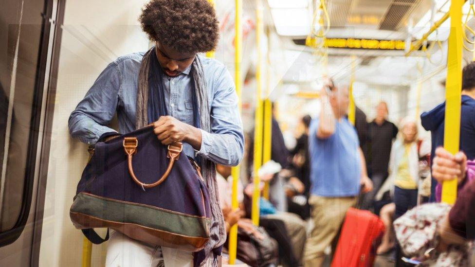 Man looking in bag