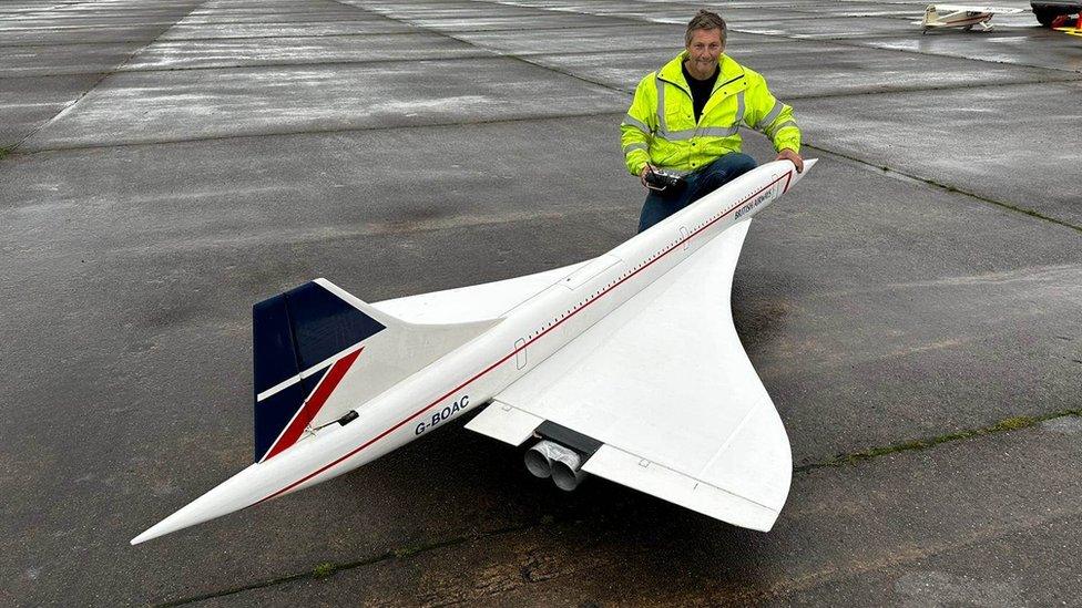 Andy Johnson next to the 11ft long model of the Concorde