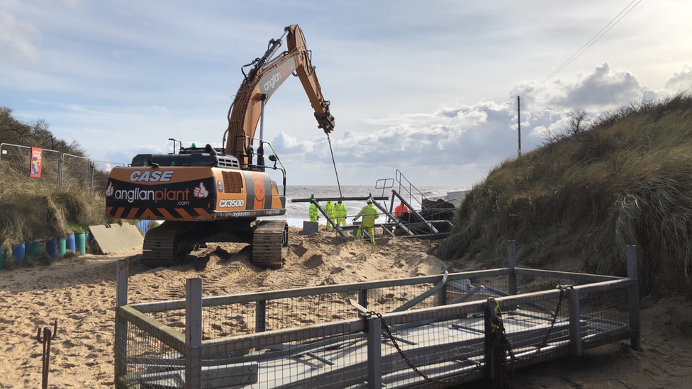 Work being done to move the washed up lifeguard hut