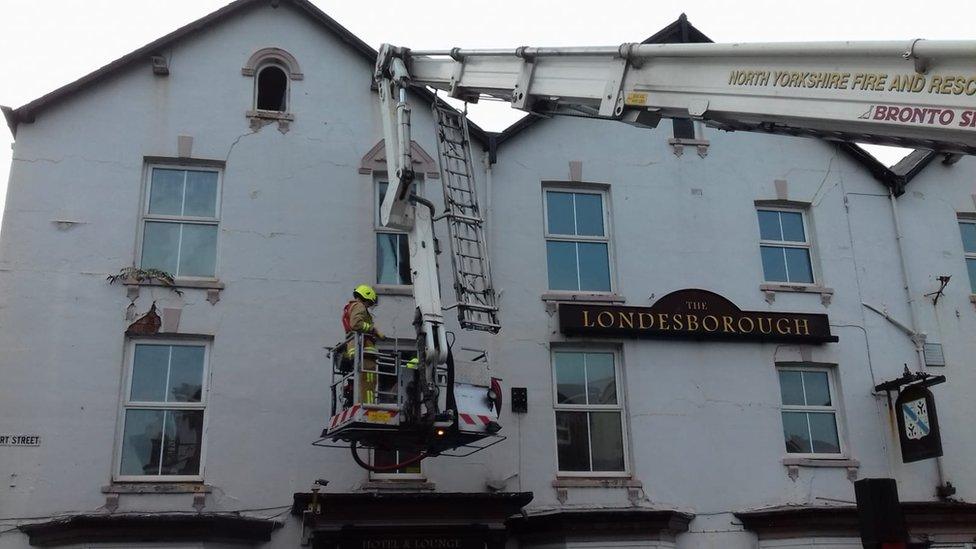 Fire officer on a crane in front of the Londesborough pub