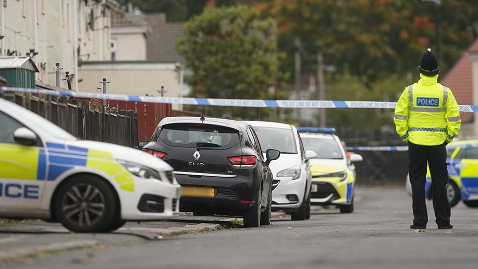 A number of police cars were parked on Maple Terrace