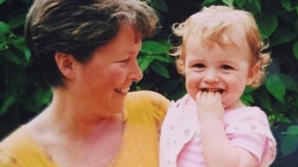 Phoebe with her mum in the garden smiling