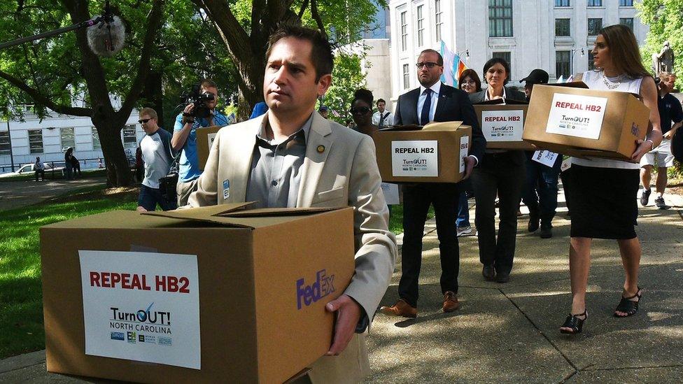 The Executive Director of Equality North Carolina, Chris Sgro, leads a group carrying petitions calling for the repeal of House Bill 2 to Governor Pat McCrory's office