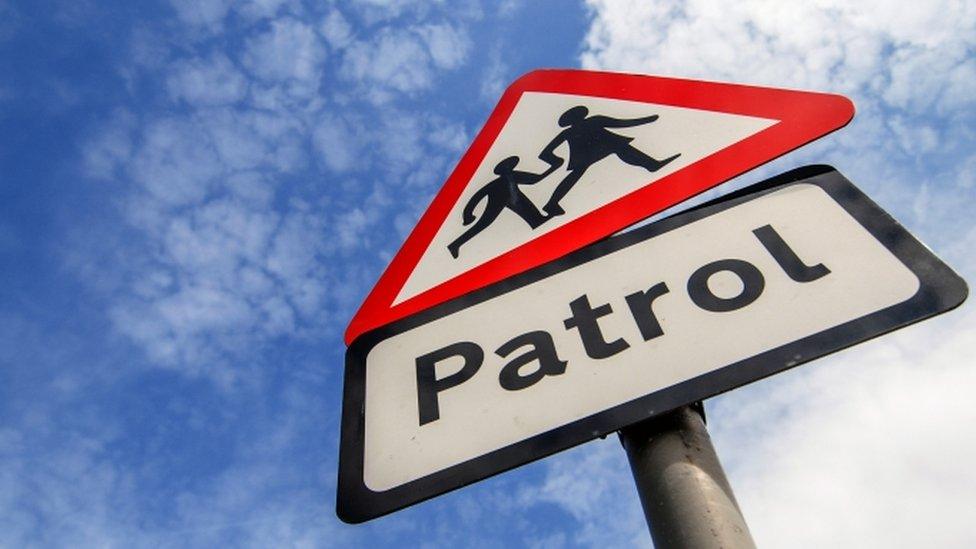 School children crossing patrol sign