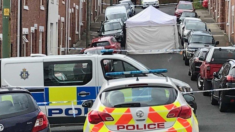 Police vehicles, a cordon and a tent erected at Melville Street