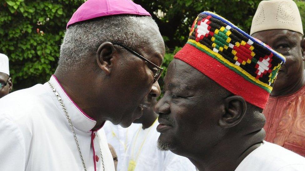 Archbishop of Ouagadougou Philippe Ouedrago (L) wishes a good Eid the Imam of Ouagadougou's Grand Mosque El Hadj Aboubacar Sana (R) in Burkina Faso, 2012