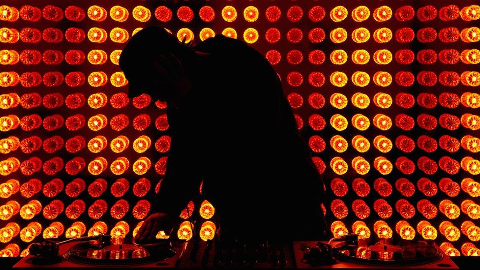 Stock image of a DJ in silhouette