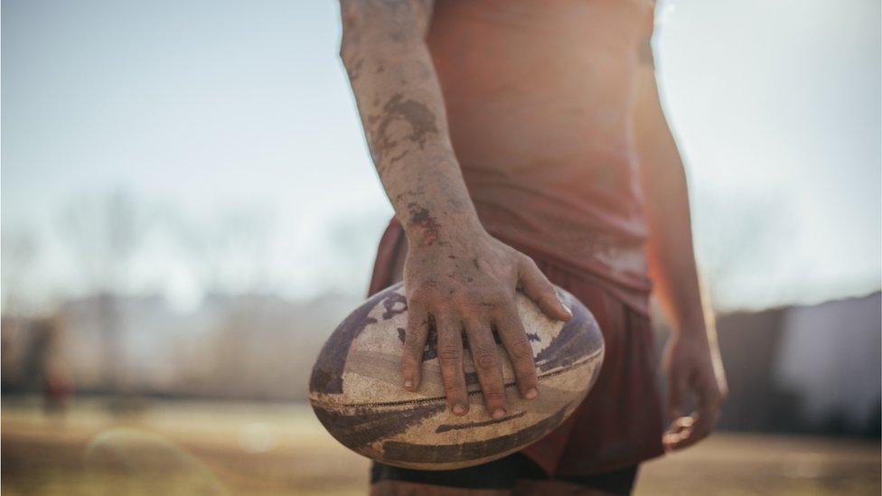 Rugby player holding ball