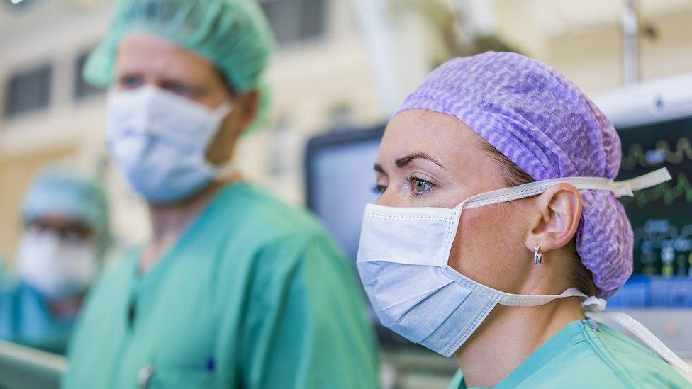 Doctors wearing scrubs and gloves