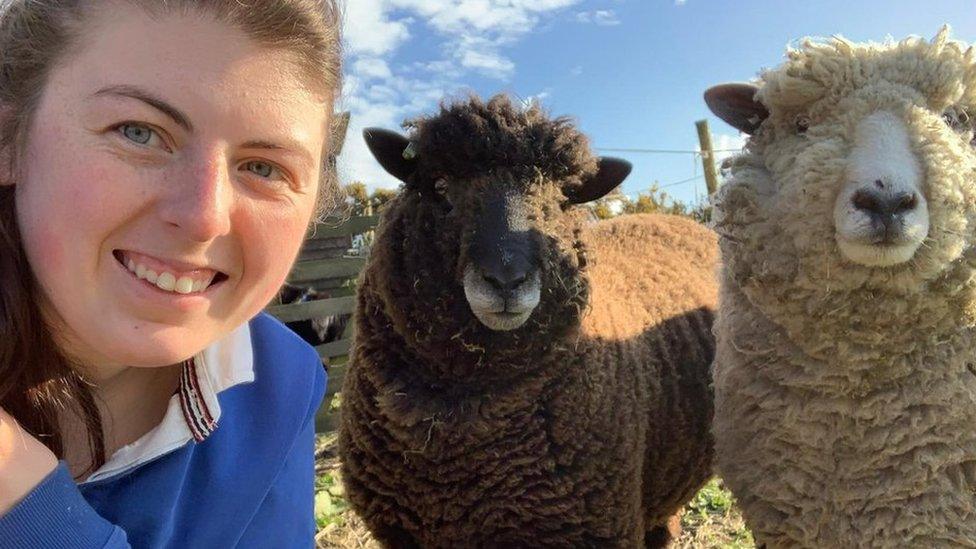 Selfie of Kelsey with two of her sheep