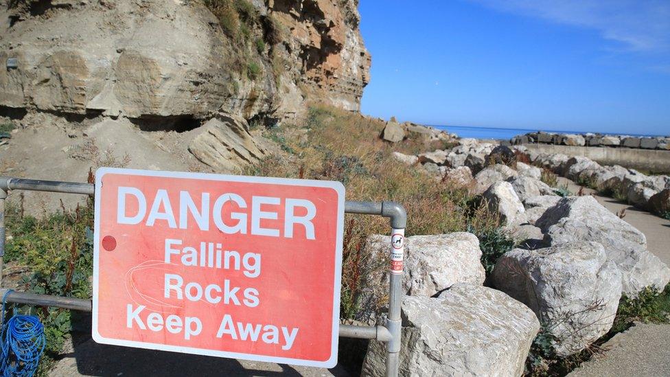 Warning sign reading 'Danger Falling Rocks Keep away'