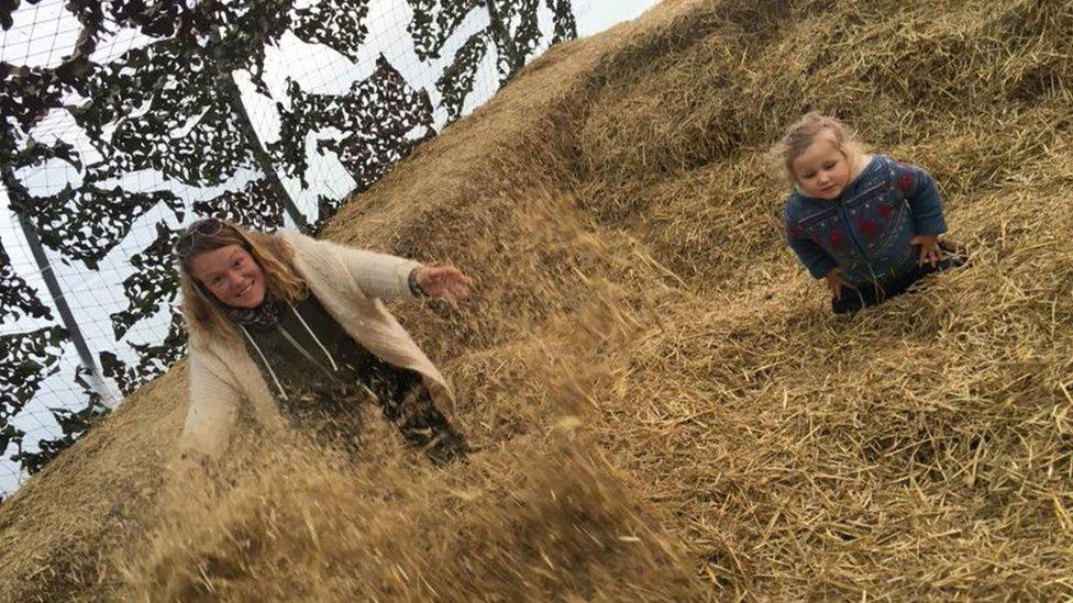 Lynn Stevenson and her four-year-old daughter Arya in the straw pit in Briarlands Farm near Stirling