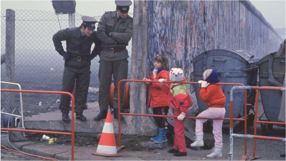 west-german-school-children-chatting-to-border-guards.